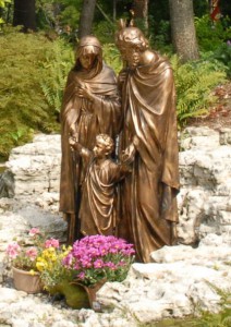 The pathway to the Marian Grotto of Our Lady of Lourdes at SS. Cyril and Methodius Seminary features a waterfall beside a large bronze statue of the Holy Family. 