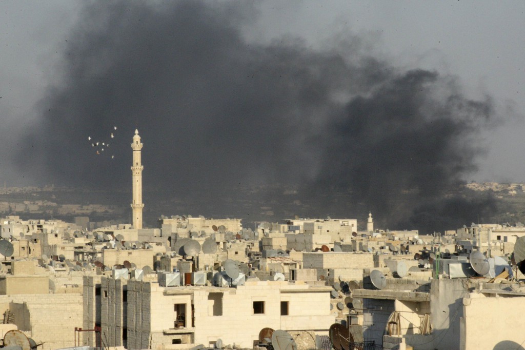 Smoke rises amid buildings in Syria