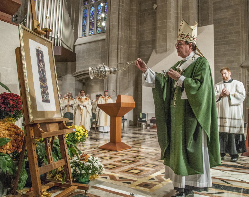 Archbishop Allen H. Vigneron blesses an image of St. Anne, which was given Sept. 30 to each parish that participated in the Changing Lives Together campaign.