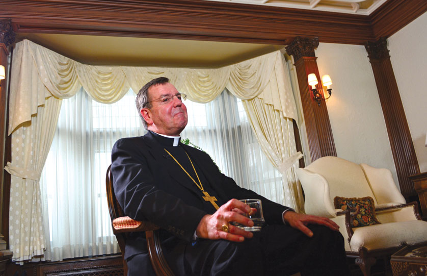 Smiling, Archbishop Allen H. Vigneron pauses for a drink of water during an interview with The Michigan Catholic for his five-year anniversary. Of all the aspects of his ministry that give him joy, teaching and helping someone experience Christ top the list, he said. “There isn’t anything more sacred than the space between a soul and God,” he said. “When I am invited into that … it’s a great, great blessing.” 