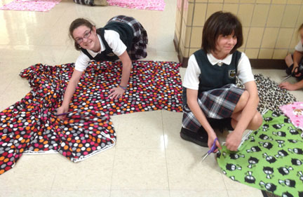 Guardian Angels School’s “Art Angels” make fleece blankets for a local animal shelter.