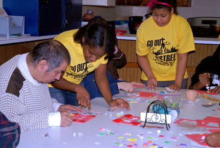 Youth group members of St. Charles Borromeo Parish in Detroit help Brighter Haven Senior Center residents make Valentine-themed picture frames. For more photos, visit gallery.themichigancatholic.com.  