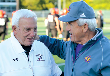 Al Fracassa, left, shares a moment with Warren De La Salle football coach Paul Verska earlier this season. As a gesture of goodwill, De La Salle offered the retiring Warriors coach a plaque honoring his achievements in the Catholic League.  