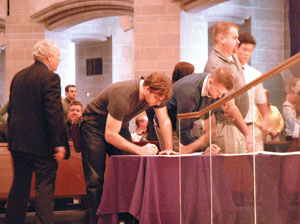 Catechumens sign their names in the Book of the Elect, pledging their desire for baptism. 