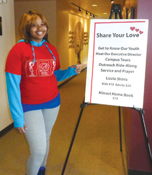 D’Shonda Atkins, a resident at Covenant House Michigan, posts at the recent Share Your Love Valentine’s event. 