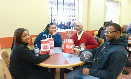 Covenant House Michigan residents Jaymie Morris, Aaliyah Ruffin, staff member Duval Evans and CHM resident Charles Glass receive Valentine’s Day treats. 