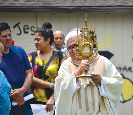 A Corpus Christi procession at SS. Andrew and Benedict Parish on Detroit's southwest side visited four altars set up to represent the parish's different heritages or ethnicities during the Feast of Corpus Christi, which was celebrated across the archdiocese June 22.