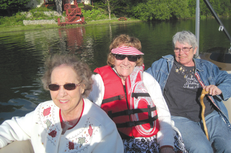 Fox Manor independent living residents Elizabeth Kish, Fern Walch and Lyane Kearns enjoy a boat outing. 