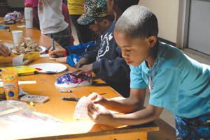 Loving Arms campers make masks while learning about showing one’s emotions on the outside.