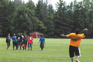 Campers at the Society of St. Vincent de Paul’s Camp Ozanam play football July 9 with a camp counselor. 