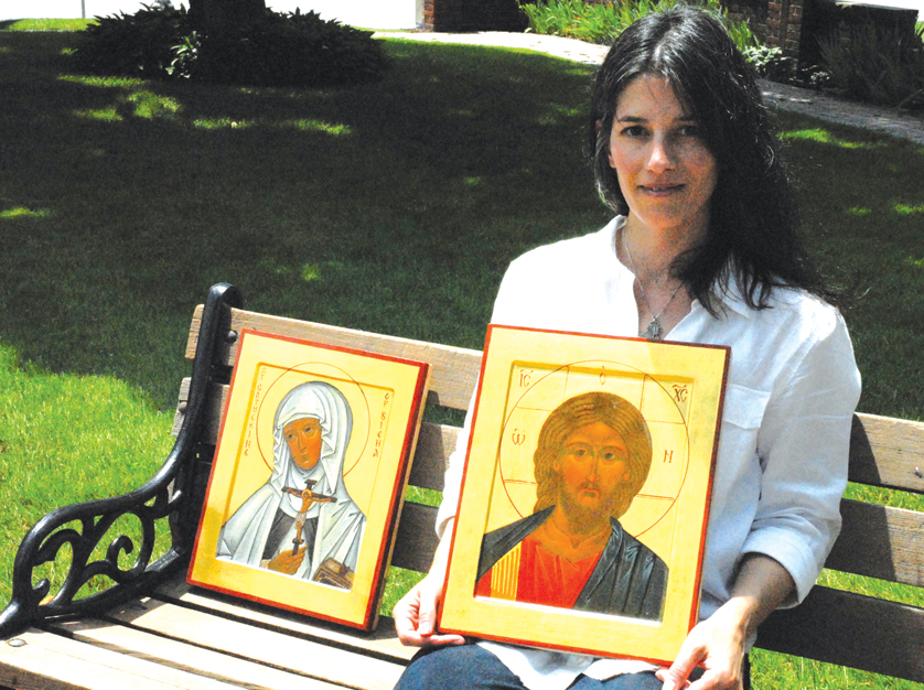 Danielle Simonson holds her icon of Christ the King on a bench outside the National Shrine of the Little Flower, Royal Oak, her parish. 