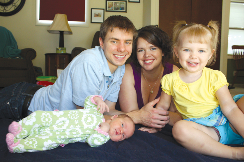 Jenelle Ponkowski, who coordinates natural family planning for the Archdiocese of Detroit, smiles with her husband, William, and daughters Maria (left) and Gabby (right). Ponkowski says a lot of the hesitancy associated with NFP is based on misunderstanding, but that more Catholics appear to be interested in learning.