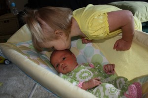 Gabby Ponkowski, daughter of Jenelle Ponkowski, natural family planning coordinator for the Archdiocese of Detroit, kisses little sister Maria. (Family photo)
