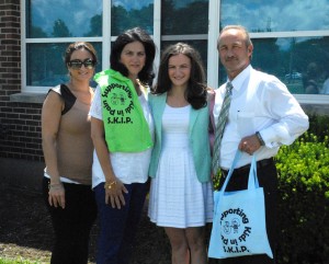 Sarah Maisano (second right), a student at Regina High School and founder of Supporting Kids in Pain, a nonprofit helping sick children, stands with her sister Gina, left, mother Sharon and father Russell in front of the Warren school. “I’m very proud of her — plus she gets all her chores done around the house on top of that!” says Russell Maisano. Not pictured are brothers Anthony and Joe.