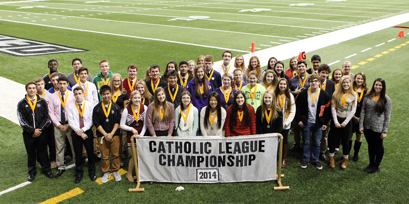 The Junior Scholastic All-Catholics – those who have achieved the highest grade-points in their junior year – stand with their medals at Ford Field. In addition to championship football, the Prep Bowl traditionally includes numerous academic awards. 