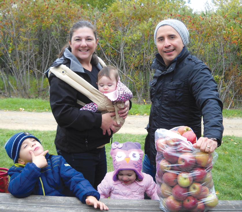 Javier and Gretchen Mena with their children Javier Jr. (5), Alice (2) and Elizabeth (8 months) strike a pose during an Oct. 5 family outing to a local cider mill.  