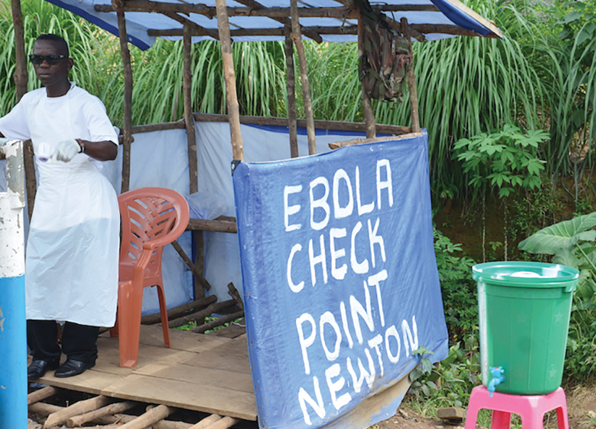 An Ebola check point outside of Freetown Sierra Leone where travelers temperatures are checked with a heat gun or thermal scanner. Catholic Relief Services has committed more than $1.5 million in private funds to continue its emergency response to the Ebola outbreak in West Africa. The number of deaths and people infected with the virus continues to increase rapidly. CRS and its Caritas partner have been working to train more than 400 volunteers on key messages about Ebola as well as psychosocial counseling for those who’ve lost loved ones to the disease. Education is the only way to stop the spread of the disease, so CRS has been working on public awareness campaigns aimed at teaching the population about Ebola, including its spread and prevention.  Photo by Michael Stulman/Catholic Relief Services