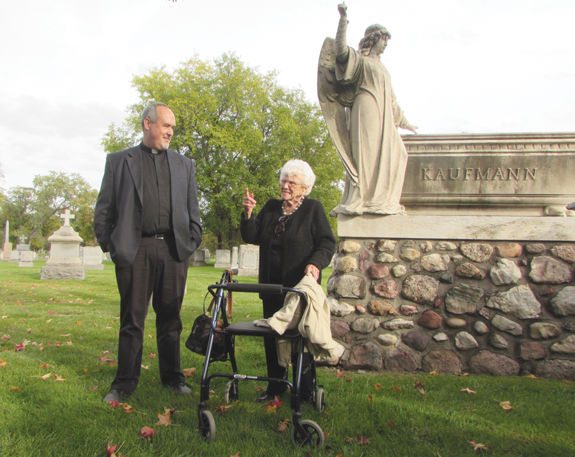 Fr. Michael Depcik and Helen Booker, a member of the Detroit Catholic Deaf ministry, visit Detroit’s Mount Olivet Cemetery, where Fr. Henry Kaufman and Fr. Raymond N. Ellis — both influential in bringing Catholic Deaf ministry to Detroit — are buried.