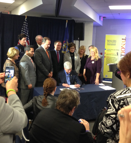 ichigan Gov. Rick Snyder signs a 22-bill package creating new protections and services for victims of human trafficking Oct. 16 at Walsh College in Troy. 