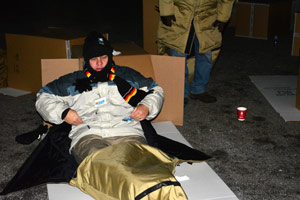 A bundled-up Dan Weingartz, president of Weingartz Supply Co., prepares his bed Nov. 20.  