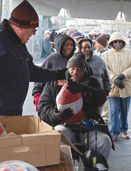 People in need line up for free Thanksgiving turkeys last year in Detroit.  The 50th anniversary of President Lyndon Johnson's declaration of the War on Poverty Jan. 8 prompted a renewed commitment by Catholic and other faith groups to address poverty. (CNS photo/Jim West) (Jan. 9, 2014) See POVERTY Jan. 9, 2014.