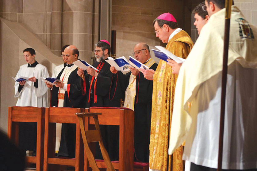 Right to left, Archbishop Allen H. Vigneron joins Syrian Bishop Barnaba Yousif Benham Habash, Chaldean Bishop Francis Kalabat and Maronite Bishop Abdullah Elias Zaidan at a Nov. 21 prayer service joining local Eastern and Western Catholics to pray for God’s protection for the Middle East. 