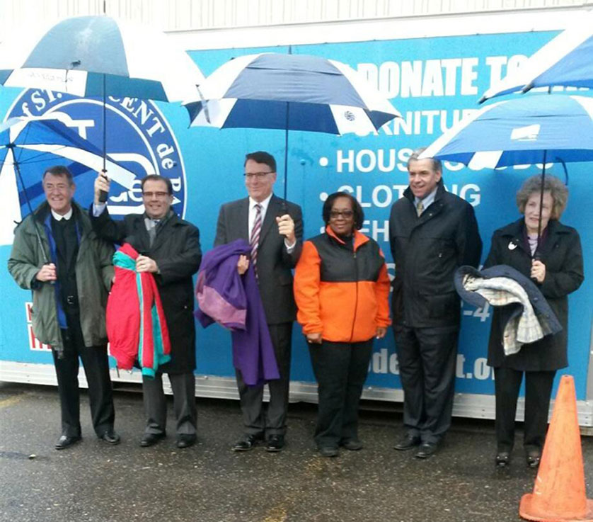 Officials from the Society of St. Vincent de Paul help kick off the agency’s “Operation Coat Check” initiative Nov. 6 in downtown Detroit.