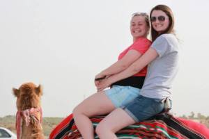 Jackie Beltowski and Megan Luttinen ride a camel while on a senior-class trip to the Holy Land last year.