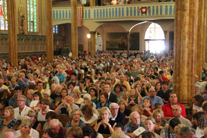 Mass-goers pack the pews of St. Albertus Church on Aug. 10 during the fifth Detroit “Mass Mob,” which aims to fill a different city church each month. 