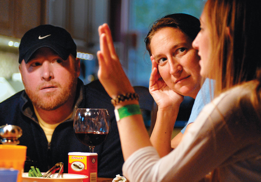 Parents listen to their teenage daughter during dinner in the family's home in 2011. Experts say talking with your children at home about appropriate TV programming is the best solution to concerns about indecent language or images. The Supreme Court heard oral arguments Jan. 10 in a case pitting broadcasters against the federal government over whether it has the authority to punish the airing of indecent material on TV. (CNS photo illustration/Sid Hastings) (Jan. 20, 2012) See WASHINGTON LETTER Jan. 20, 2012.