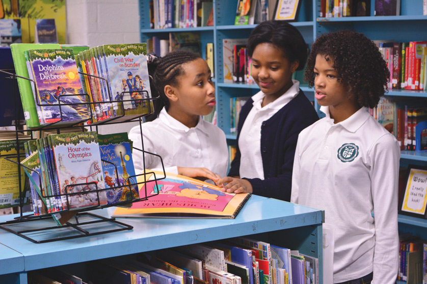 Students at Gesu Catholic School in northwest Detroit pick out books to read for the week during the school’s “library day” Jan. 12. The school recently updated its decades-old library with help from the community, including The Book Beat, an independent bookstore in Oak Park.