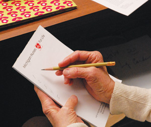 Phyl Sallee takes down notes during a Michigan Nurses for Life meeting at their Troy office. 