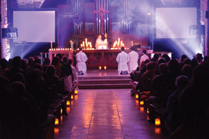 Incense, smoke and special lighting illumine the altar during the Eucharistic adoration portion of the event.