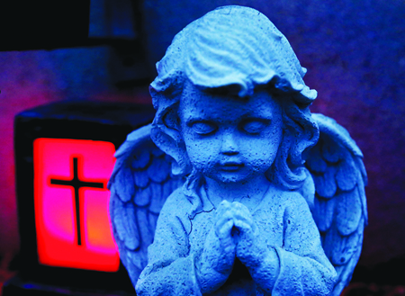 Angel statue pictured at grave during dusk at cemetery in western Austrian village of Absam
