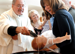 A priest baptizes an infant at Christ the King Church in Irondequoit, N.Y., in this 2007 file photo. In the Catholic rite the minister uses the invocation "I baptize you in the name of the Father and of the Son and of the Holy Spirit." (CNS file photo/Mike Crupi, Catholic Courier)