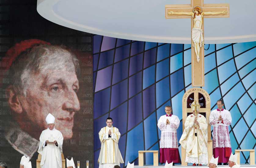 Pope Benedict XVI leads Mass and the beatification of Cardinal John Henry Newman at Cofton Park in Birmingham, England, Sept. 19. Blessed Newman, a 19th-century theologian and a prolific writer on spiritual topics, left the Anglican Church and embraced Catholicism at the age of 44. An image of Blessed Newman appears at left. (CNS photo/Andrew Winning, Reuters)