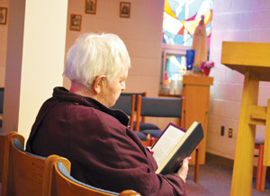 Audrey Bolstrum prays for the intentions of those on the “prayer line” in the adoration chapel of St. John Bosco Parish in Redford. 