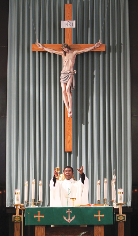 Father Jerome Madumelu elevates the Eucharist during Mass at Good Samaritan Hospital Medical Center in West Islip, N.Y., Feb. 11. (CNS photo/Gregory A. Shemitz, Long Island Catholic) (Feb. 22, 2011) See EUCHARIST-REVERE and EUCHARIST-RECEIVE Feb. 22, 2011.