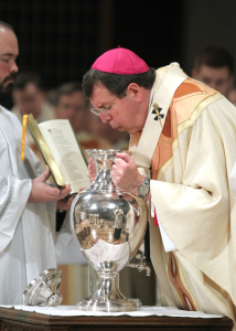 Archbishop Allen Vigneron breathes into the Holy Chrism during the consecration of the oils during the annual Chrism Mass at the Cathedral of the Most Blessed Sacrament on Holy Thursday, April 2. (Photos by Mr. Mack Photography)