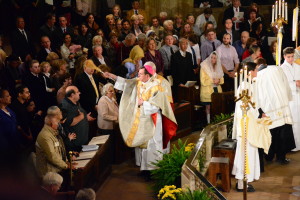 Archbishop Vigneron blesses the congregation with holy water.