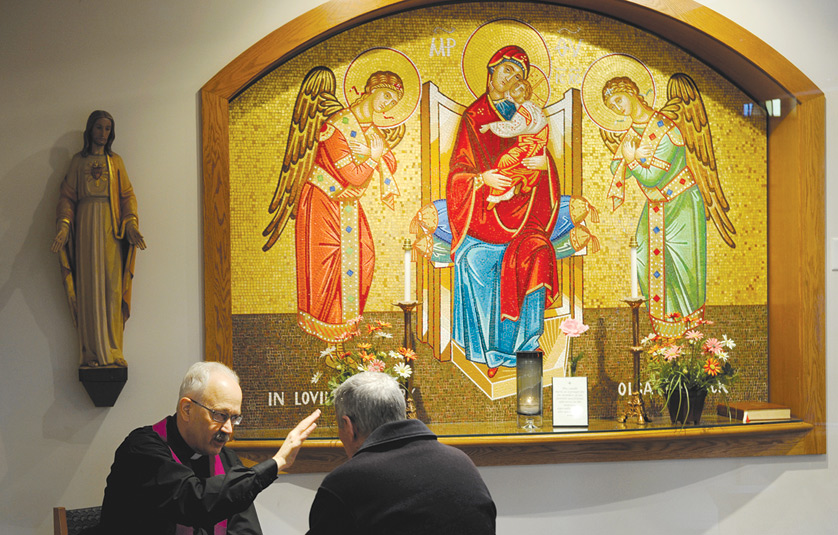 A priest hears a confession in 2013 at Christ the King Church in Irondequoit, N.Y. Don't be too lax or too harsh during confession and always make sure people know when the sacrament of reconciliation is available, Pope Francis said. (CNS photo/Mike Crupi, Catholic Courier) (March 28, 2019) See POPE-CONFESSION March 28, 2014.
