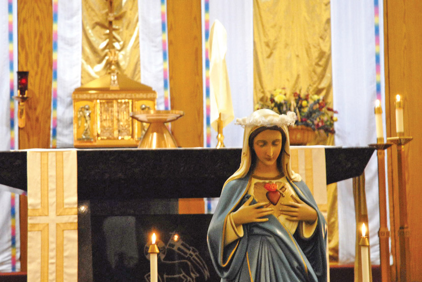 A statue of the Blessed Mother is seen in front of a tabernacle at St. Anne Parish in Warren in 2012.  