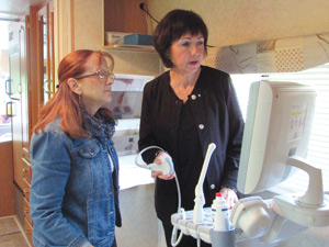 Sonographer Marion Sioma, right, and Bev Dixon fire up the ultrasound machine inside the converted RV on May 21. 