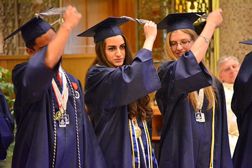 From left, Taelase Leota, Regina Marogi and Nora Walker flip their tassels as part of the first graduating class for the archdiocese’s newest high school, Austin Catholic High School in Ray Township.