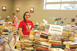 Veronika Boley from Our Lady of Sorrows in Farmington works at the used book sale to help fund her trip to World Youth Day in Poland next year.  