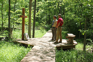 Christopher Kehrer and his father, David, pause to look at the fifth station. The Kehrers spent three summers working to complete the trail in Armada.
