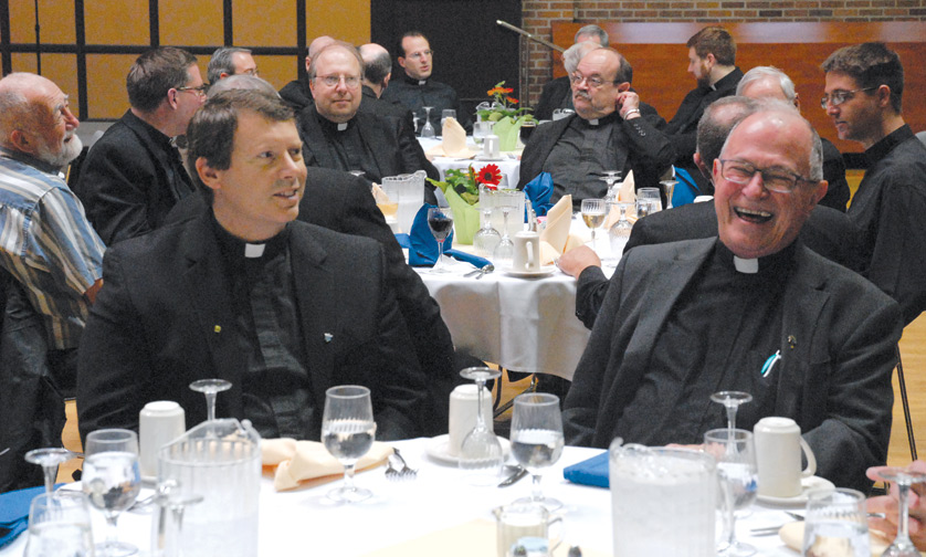 Fr. James Kean, left, pastor of St. Damien of Molokai Parish in Pontiac, and Fr. Richard Hartmann, who retired in 2014 as pastor of St. Roch Parish in Flat Rock, enjoy fellowship at the jubilarians' luncheon.