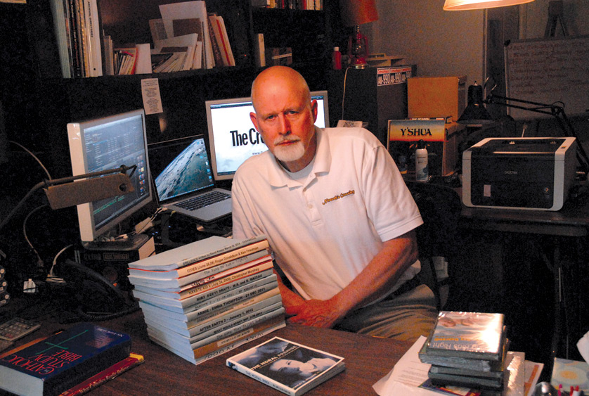 Producer and filmmaker Stan Williams sits in his home office in Northville, surrounded by his recent projects and work. Williams, a convert to Catholicism,  has made it his career's mission to showcase the beauty of the Christian faith through compelling film and storytelling.