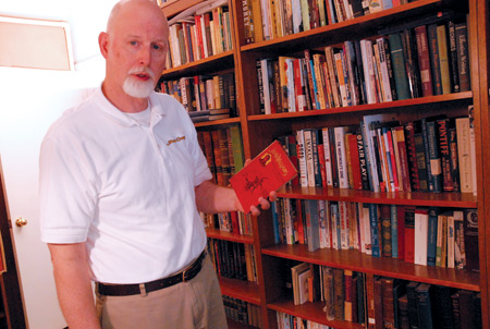 Filmmaker Stan Williams holds up a book written by his uncle, John Williams, on one of his ancestors; missionary work in the South Pacific. The book inspired Williams to pursue a career in Christian media.