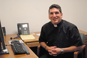 Deacon Dominic Macioce, a transitional deacon seminarian, sits in the office at St. Hugo of the Hills Parish in Bloomfield Hills, where he is an intern this summer. Each year, seminarians in their third and fourth years of theology at Sacred Heart Major Seminary learn the ins and outs of parish life through internship experiences.